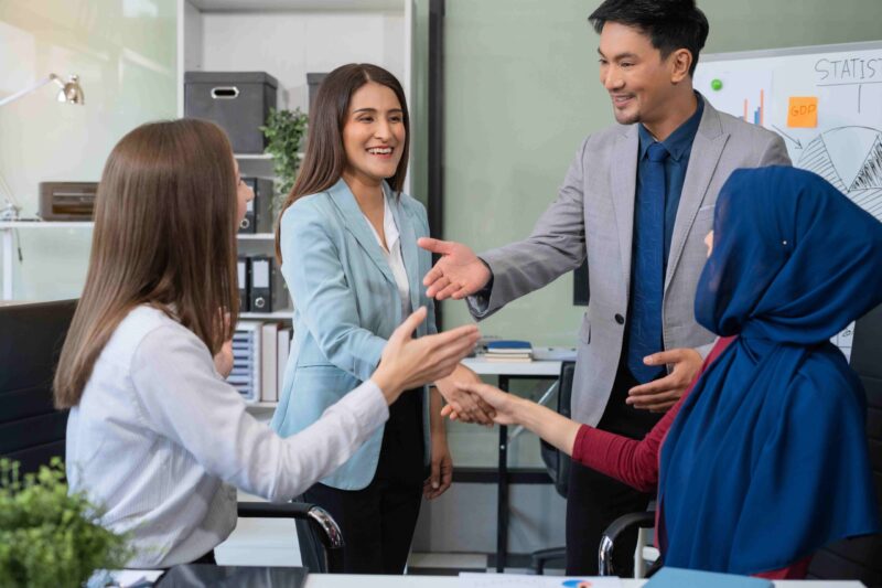 “Professionals building strong workplace relationships through interpersonal skills.”