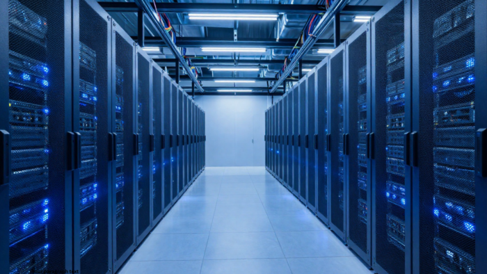 Modern data center server room with rows of network and server racks, blue LED lights, and enterprise IT infrastructure for data center operations and CDCP certification training.