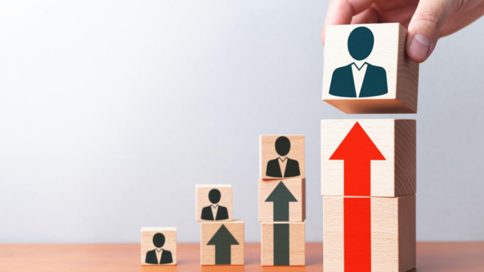Career advancement concept showing professionals progressing upward through different levels toward promotion