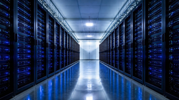 Modern data centre server room with rows of server racks and blue LED lights.