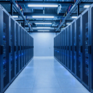 Modern data center server room with rows of network and server racks, blue LED lights, and enterprise IT infrastructure for data center operations and CDCP certification training.