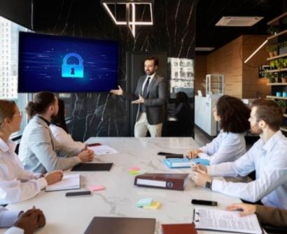 Corporate cyber security training session with employees attending a data protection and cyber awareness presentation in a modern office meeting room.