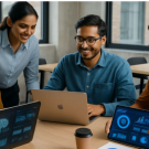 Group of Indian working professionals collaborating on laptops and tablets during an AI and data analytics training session in a modern office environment.