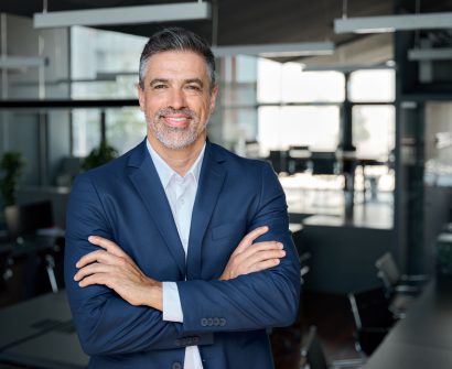 happy-middle-aged-business-man-ceo-standing-in-off-2026-01-08-00-19-39-utc-scaled-1.jpg